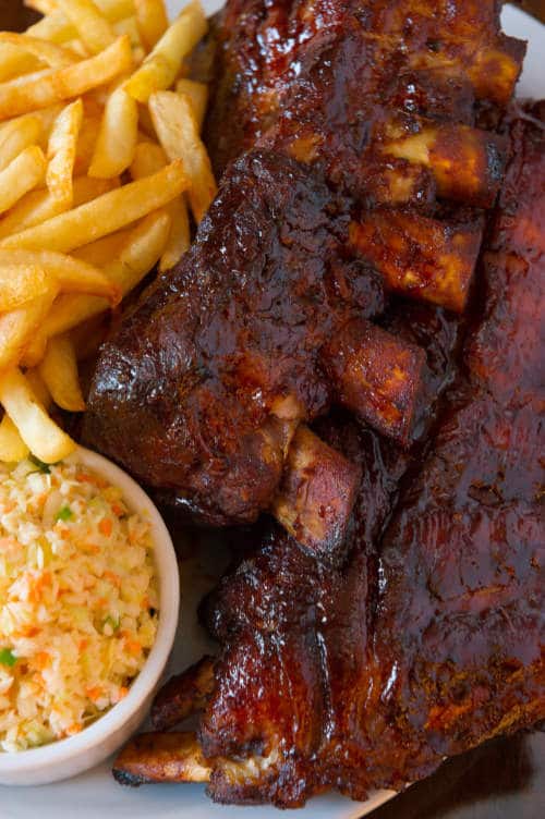 Pork ribs back with french fries and coleslaw salad on the side.